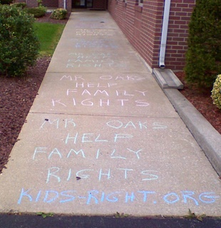 Assemblyman Robert Oaks - chalk outside office to help family rights.